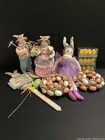 Full view of the Easter decorations lot including three bunny figurines, two wreaths, and boxed chicks.