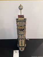 Front view of the Times building figurine with 'Happy 2000' sign and silver ball on top, showing electrical cord without plug.