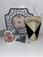 Overview of the trivet, welcome basket, floral decor, and glass polar bear figurine showing set contents and condition.