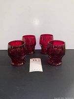 Four Viking ruby red honeycomb glasses front view