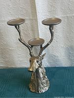 Front angle showing the detailed deer head base and three antler candle plates.