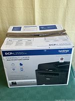 Box of Brother DCP-L2550DW multifunction laser printer copier, front and angled view showing product branding and details.