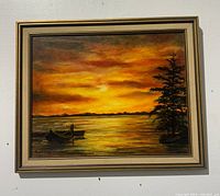 Framed oil painting of a sunset scene with two boats on water and trees on right, signed A.Jarvis.