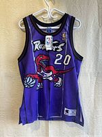Full front view of purple mesh jersey showing dinosaur logo, number and overall condition
