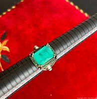 Close-up of the men's silver ring on a ring sizing tool showing the large blue stone and silver details.