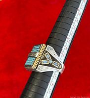 Front view of vintage men's silver ring with blue stones on ring sizing stick showing size 10.