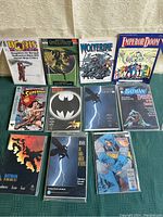 Full view of 11 vintage comic books spread on a table with covers clearly readable.