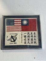 Framed vintage Blood Chit showing American and Chinese flags, markings A.A. Wilson, VPB 108, Shanghai, Tsingtao, housed in glass steel frame.