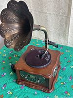 Front-side view of the LuguLake vintage phonograph with copper horn on wooden base showing turntable and control panel