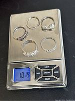 Five silver rings on measuring scale showing total weight 10.19 grams