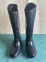 Front view of the pair of black quilted rubber rain boots showing shape and overall condition.