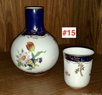Front view of Limoges porcelain water carafe and matching cup on wooden surface