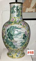 Front view of bulbous vase with landscape medallion and floral border