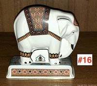 Front and side view of the Wedgwood elephant figurine on a wooden surface showing detailed patterned decoration.