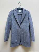 Full front view of grey blazer on hanger