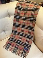 Scarf draped over a chair showing full front pattern and fringe.