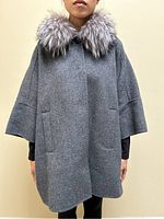 Front view of coat on model showing silhouette, collar and pockets