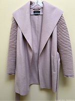 Front view of dusty rose Sentaler coat on hanger showing open silhouette and wide shawl collar