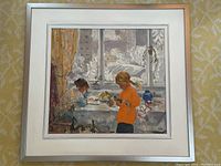Front view of framed painting showing two children at a table by window