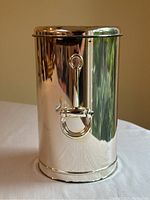 Front view of cylindrical silver plated cooler with horsebit handle