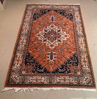 Full overhead view of entire rug showing central medallion, border and one fringe