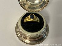 Ring displayed in open round jewelry box