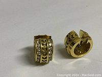 Front view of both earrings showing diamond rows and chevron pattern