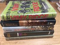 Stack of five hardcover books on a wooden surface, titles mostly visible, focused on Canadian WW1 history