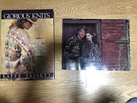 Both fiber arts booklets by Kaffe Fassett placed on wooden floor, showing front covers.