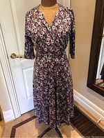 Front view of the Karina floral dress on a mannequin showing dress length, sleeve length and V-neckline