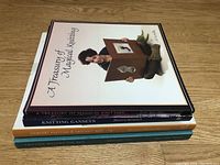 Photo of four knitting books stacked, showing titles and authors on spines.