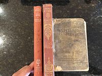 Three old books placed side by side showing their spines and front covers: 'Little Women', 'Jane Eyre', and the heavily worn 'Ontario Readers Fourth Reader'.