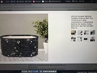 Black foldable portable bathtub with space-themed print shown in room setting on floor.