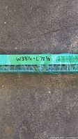 Close-up photo of the size labeled 38 1/4 inches wide by 78 5/8 inches long on green tape wrapped around the blind roll.