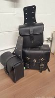 Three black leather motorcycle bags showing overall set and arrangement.