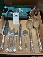 Overall assortment of flatware, wooden spoons, and shakers in box