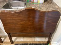 Front view of Gibbard twin bed wooden headboard with curved top edge and wood grain finish.