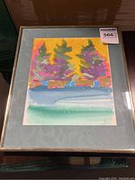 Framed mixed media artwork showing abstract trees and colorful background.