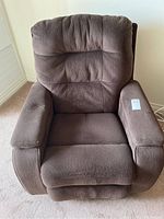 Front view of dark brown fabric recliner chair with padded backrest and cushioned armrests.