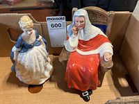 Both Royal Doulton figurines Alison and Judge side-by-side in a cardboard box