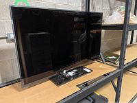 Samsung 46-inch TV on a metal rack, showing front screen and swivel base.