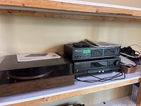 Wide angle photo showing the stereo system components including the Dual 510 turntable on the left with wood base and dust cover. The Technics SA-GX170 receiver is positioned below the Yamaha GE-20 equalizer, with assorted cables nearby.