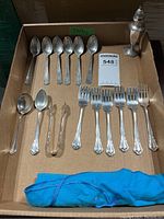 Overview of flatware and pepper shaker in box
