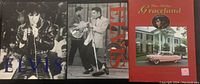 Front covers of three coffee table books: two Elvis Presley themed with black and white photos, one Graceland themed in red.