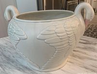 Side view of large white Fitz and Floyd ceramic bowl shaped with swan motifs on sides and swan head handles