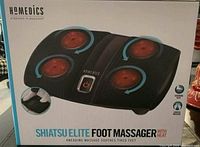 Front view of box with image and branding of Shiatsu Elite Foot Massager showing device with four red rotating massage nodes and control button.
