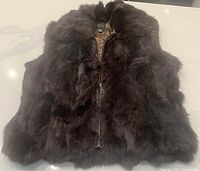 Full view of the chocolate brown rabbit fur vest with front zipper visible