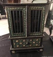 Front view of the hand painted jewellery box showing door slats and floral patterns