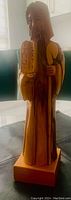 Front view of the wooden Moses statue showing detailed carving of the figure holding the tablets and staff.