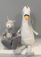 Stuffed grey kangaroo pair with baby kangaroo and a plush white swan with golden horn